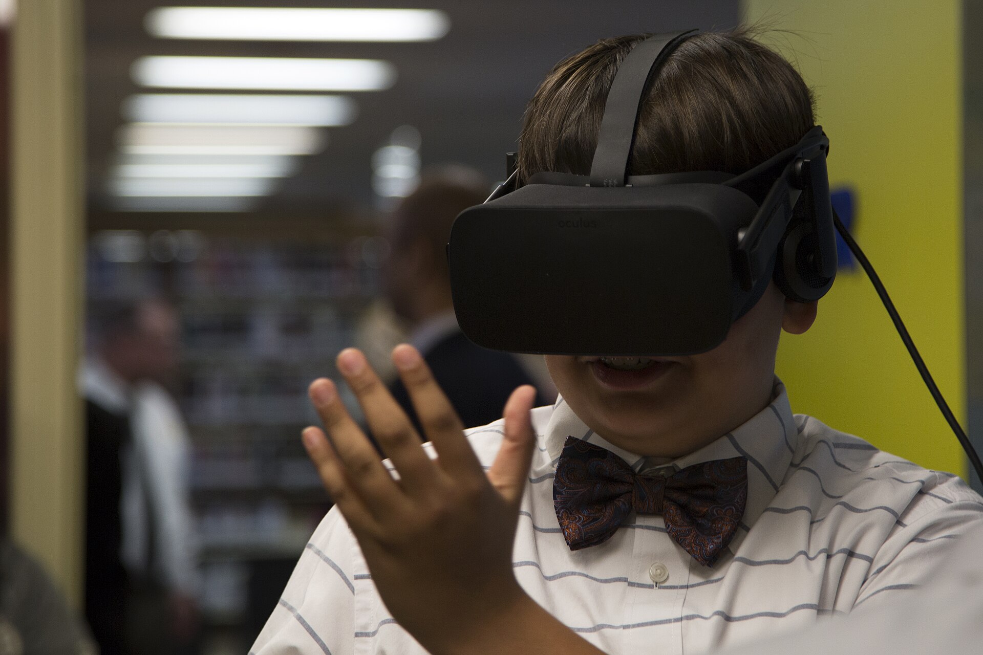 A kid reaching into virtual reality