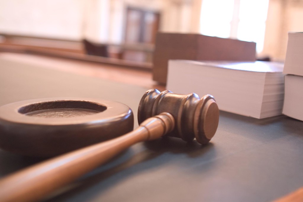 A judge's gavel resting on a desk