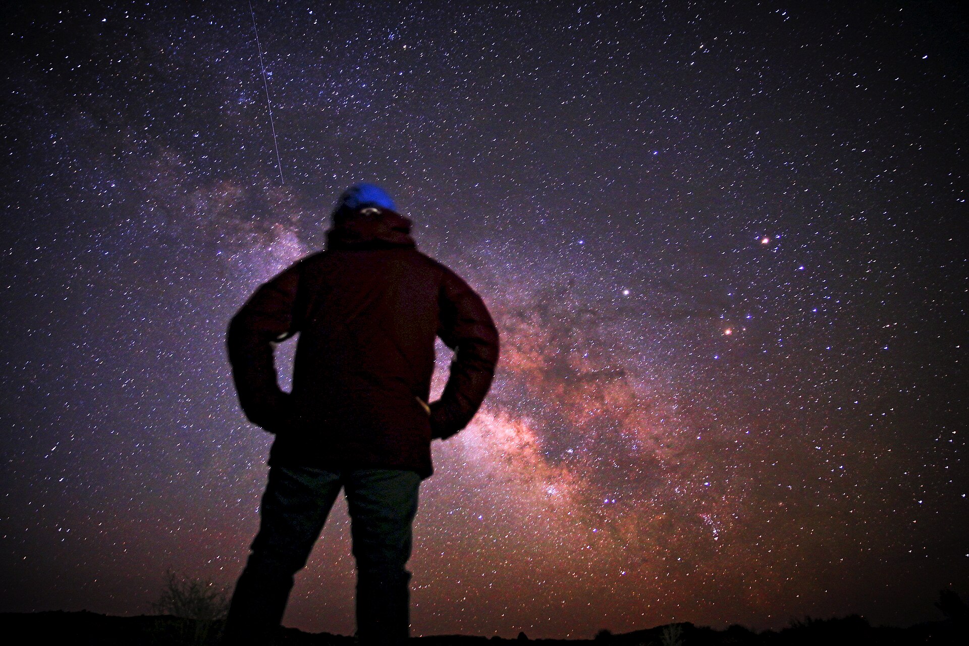 A lone figure looking up at the Milky Way