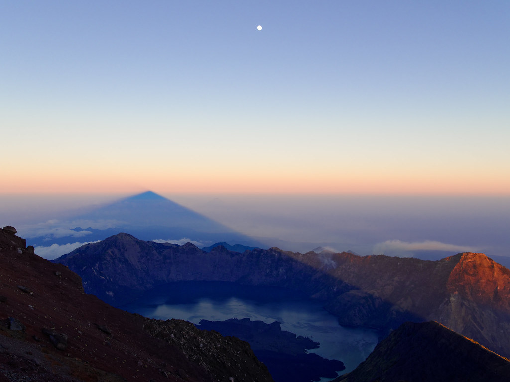 Dawn light rising in layers above a summit