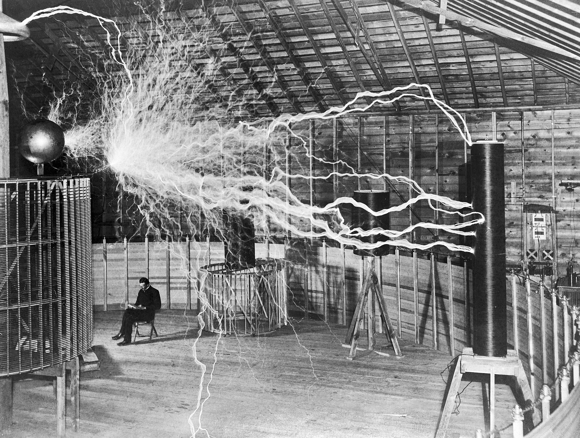 Nikola Tesla beneath giant electrical arcs